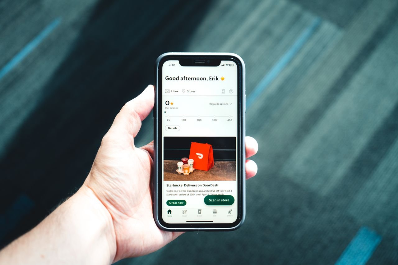 why-choose-us Close-up of a smartphone with a delivery app interface in a person's hand, emphasizing modern e-commerce.